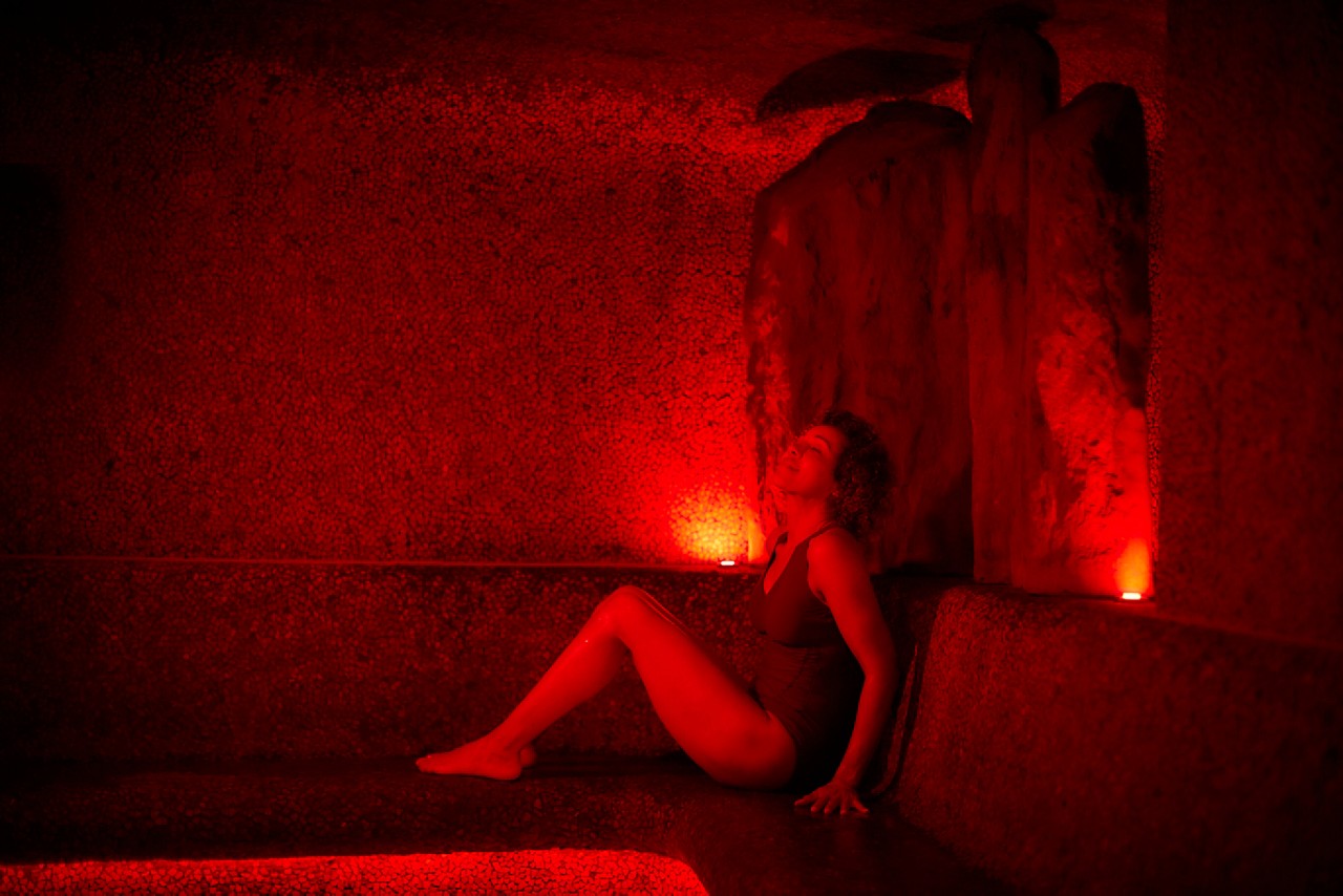 Woman relaxing in a glowing Volcanic Steam room.